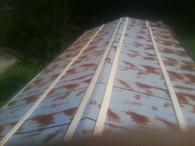 Rusted metal roof panels with new wood purlins before replacement — Storm Damage Roof Repair in Adams Run by Roofing Brothers